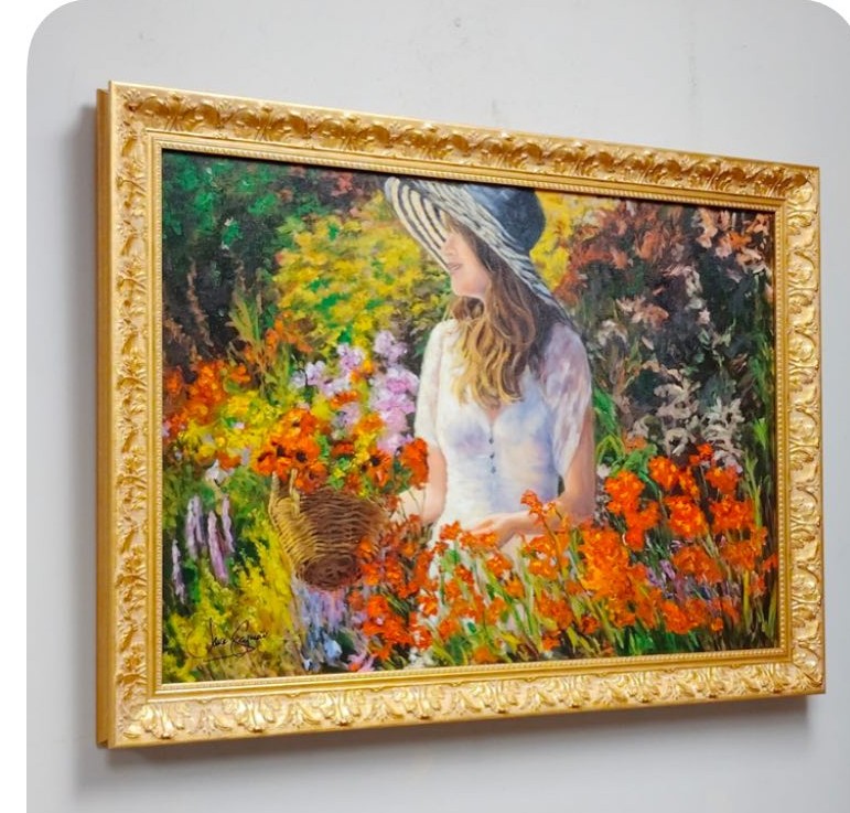 Oil painting of a woman gathering flowers in a garden, framed in an ornate gold frame