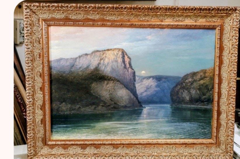 A restored canyon landscape oil painting in an ornate gold frame